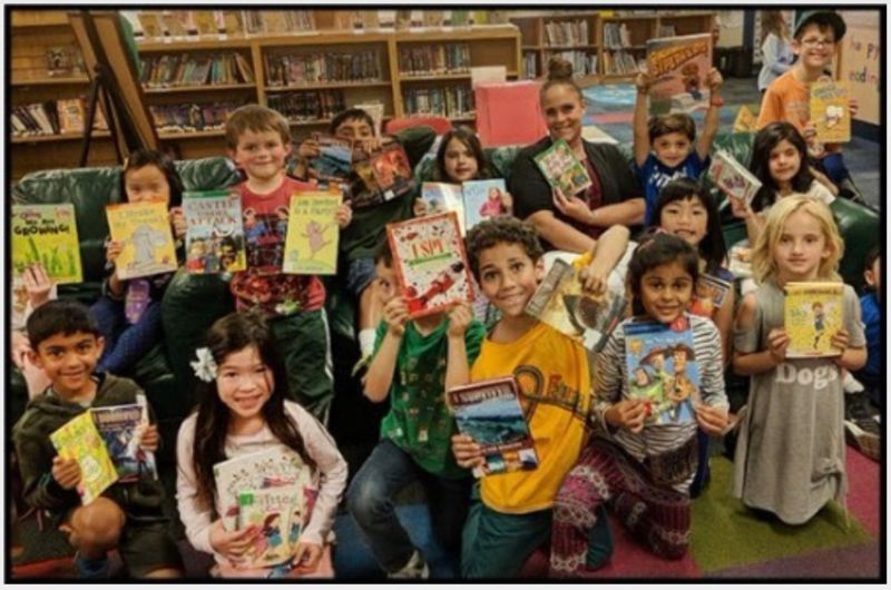 teacher and students in library