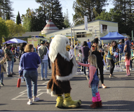 Eagle mascot with children at the festival