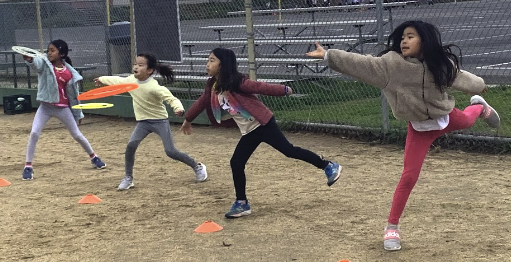 Girls throwing frisbees